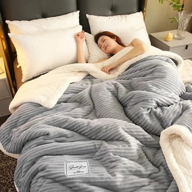 Cozy gray and cream winter fleece blanket with ribbed fleece exterior and plush white inner lining for warmth