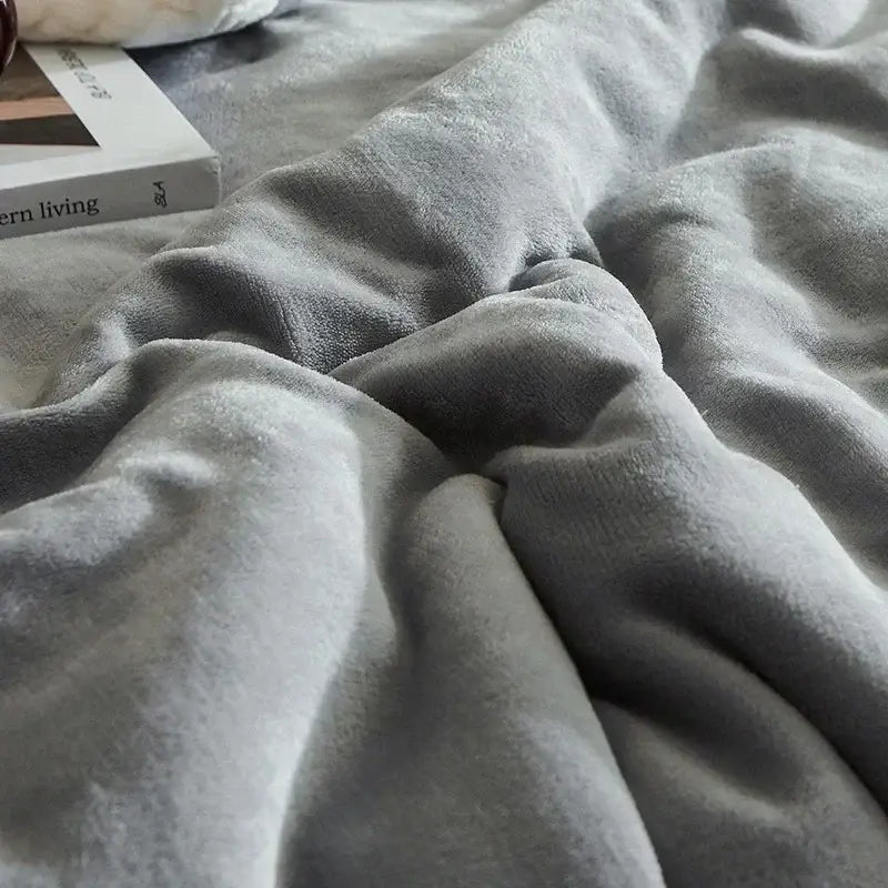 Soft gray and cream winter fleece blanket with cozy textured surface ideal for bedroom use and warmth