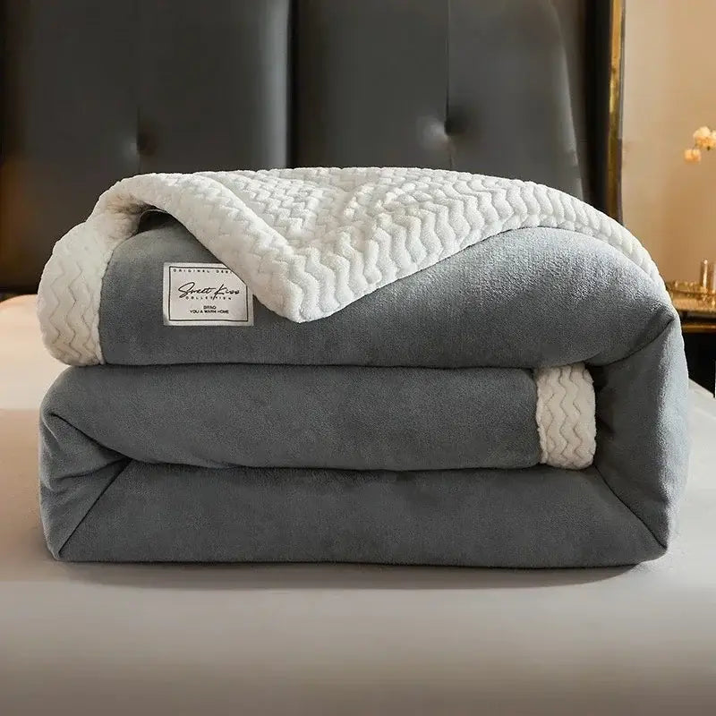 Cozy gray fleece blanket with white zigzag-patterned winter fleece lining and matching trim for bedroom use