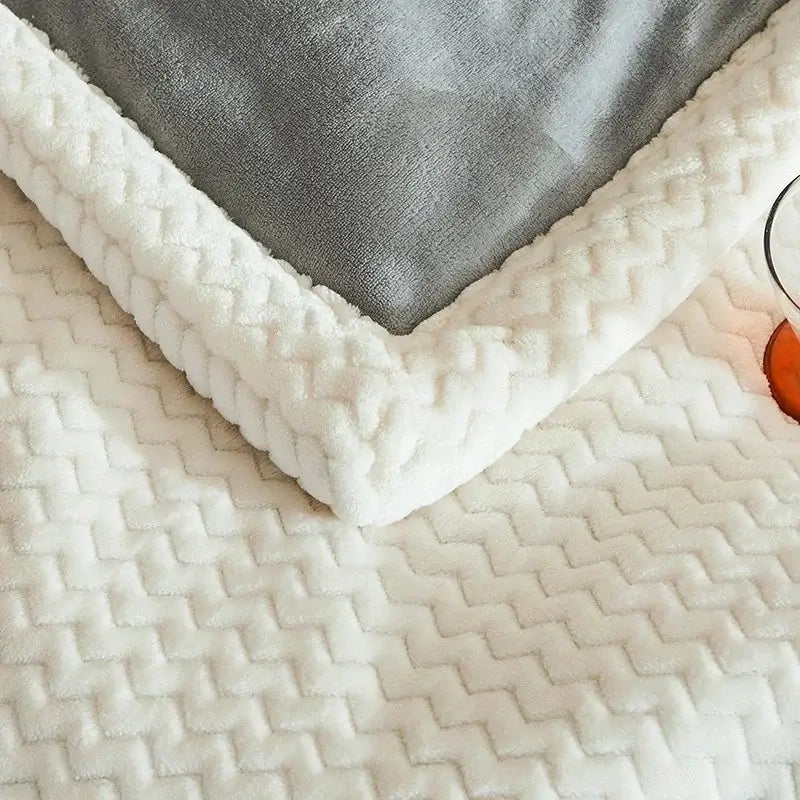 White plush fleece blanket with textured zigzag pattern and soft fuzzy border for cozy winter fleece use