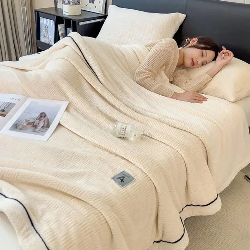 Cream-colored cozy jacquard plush blanket with black piping and gray patch soft decorbites cozy jacquard throw