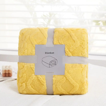 A plush bright yellow decorbites cozy jacquard blanket with a textured pattern wrapped in gray ribbon for sofa use
