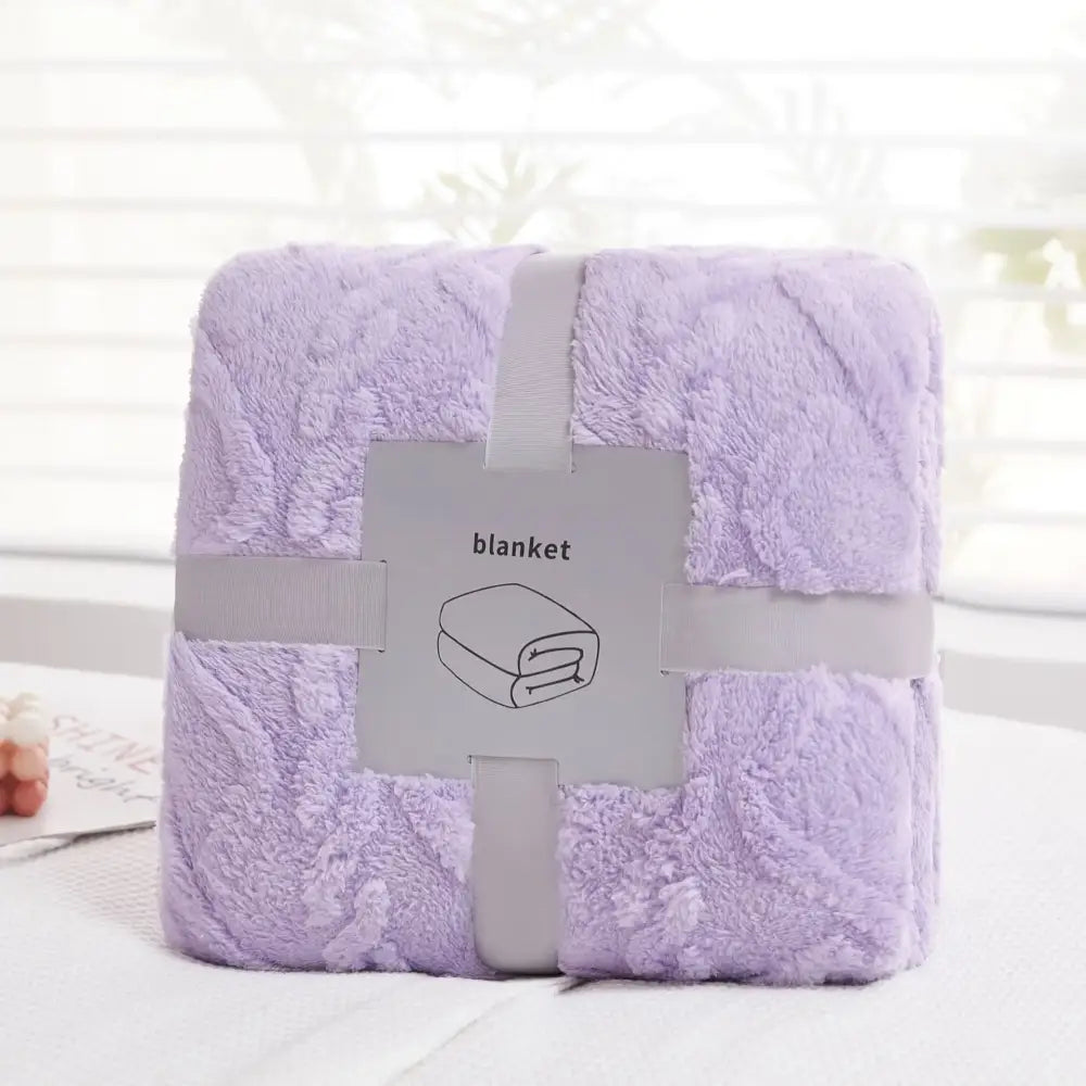 A plush lavender decorbites cozy jacquard throw blanket with soft textured surface neatly wrapped in gray ribbon