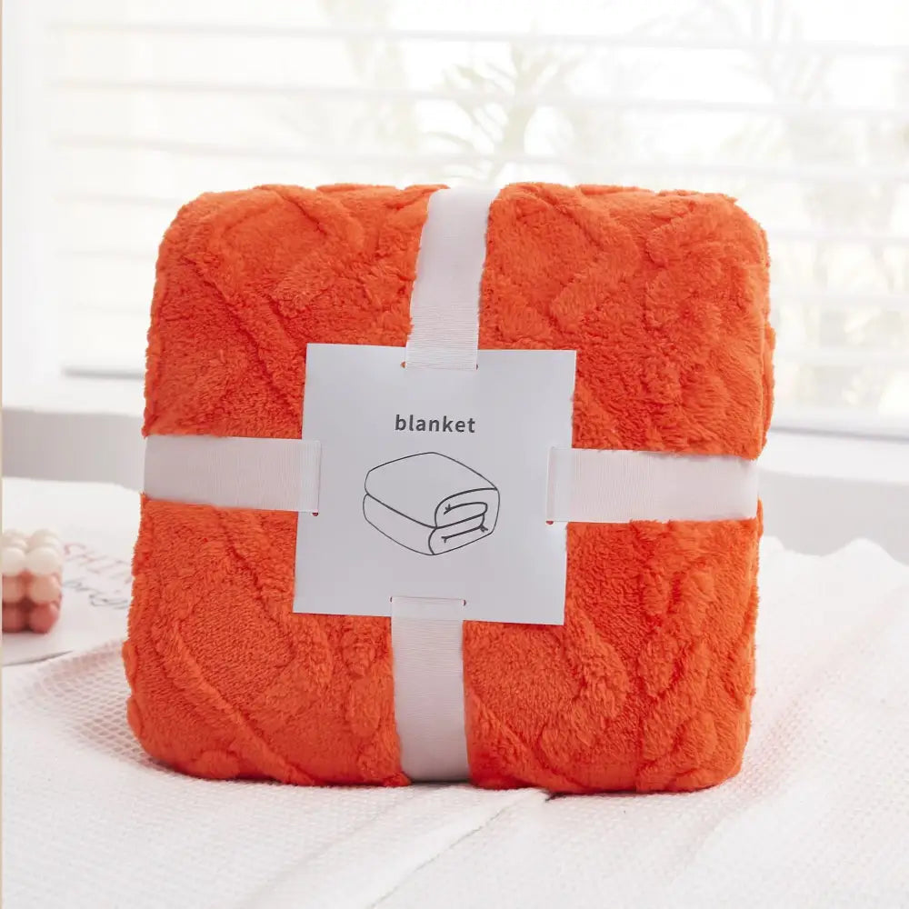 A plush orange decorbites cozy jacquard throw blanket with textured quilted pattern for living room sofa decor