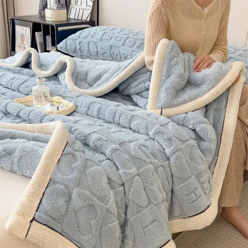 A cozy jacquard taffeta blue and cream flannel nap blanket with a textured quilted pattern for bedroom comfort