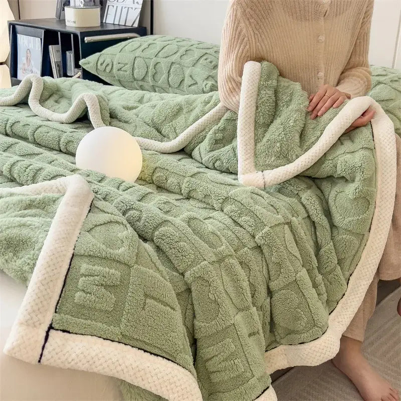 Cozy jacquard taffeta flannel nap blanket featuring a soft mint green fleece with textured knit and cream sherpa trim