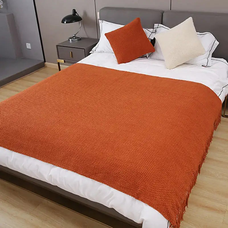 Warm orange textured decorbites cozy knitted sofa blanket with fringed edges for stylish living room decor