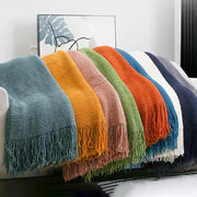 Cozy knitted sofa blanket with vibrant solid colors and textured knit featuring soft tassels for living room decorbites cozy knitted