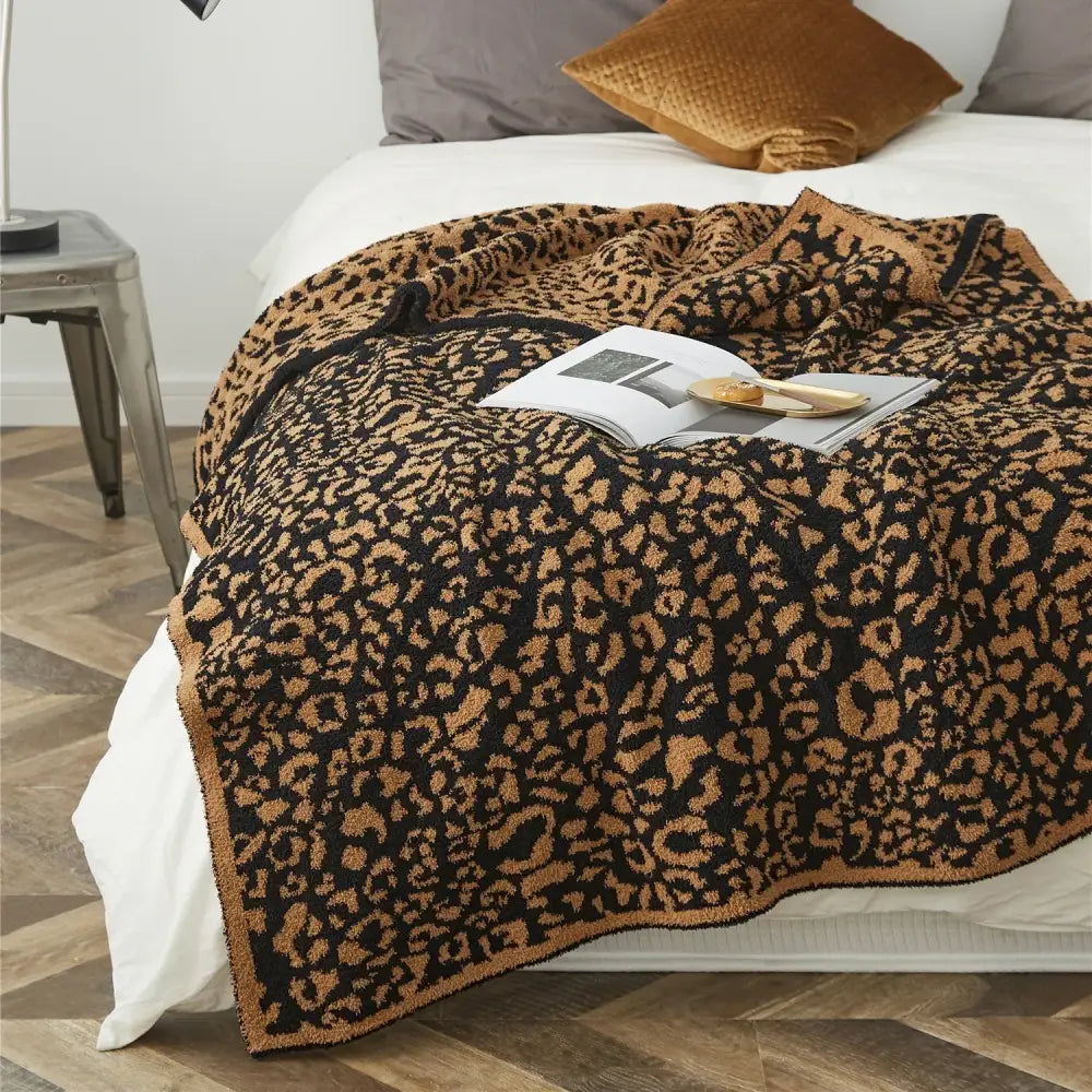 A cozy leopard print knitted black and tan throw blanket with a soft textured surface for bedroom decorbites cozy leopard
