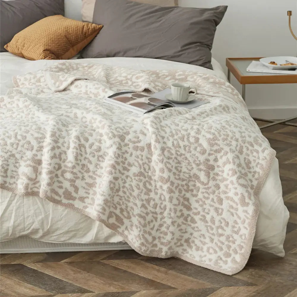 Cozy leopard print knitted cream and gray bedroom throw blanket with soft plush texture and fuzzy border by decorbites cozy leopard