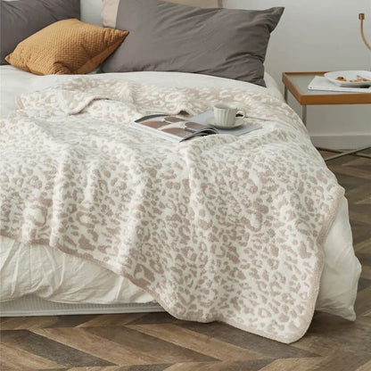 Cozy leopard print knitted cream and gray bedroom throw blanket with soft plush texture and fuzzy border by decorbites cozy leopard