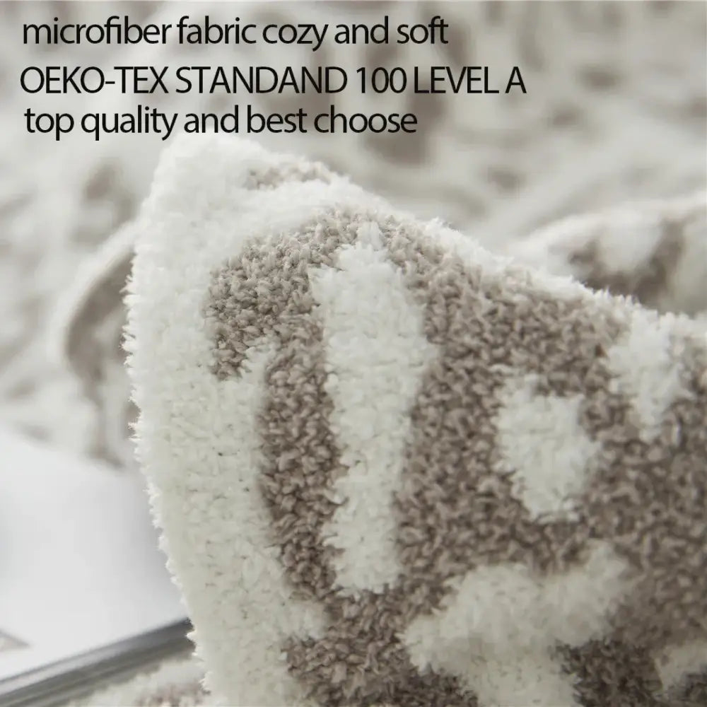 A plush cream and beige microfiber blanket with cozy textured pattern from decorbites cozy leopard print knitted collection