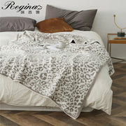 A cozy leopard print knitted bedroom throw blanket in cream with gray leopard print and textured edges by decorbites cozy leopard