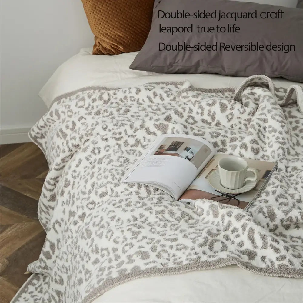 A cozy leopard print knitted double-sided jacquard throw blanket in cream and gray for bedroom decorbites cozy leopard