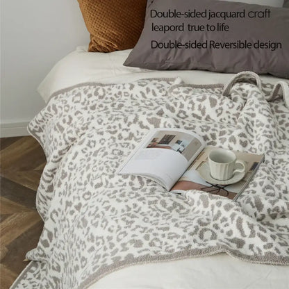 A cozy leopard print knitted double-sided jacquard throw blanket in cream and gray for bedroom decorbites cozy leopard