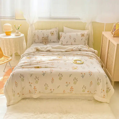 Soft cream-colored milk velvet cartoon fleece blanket with delicate floral and animal print for cozy milk velvet decorbites