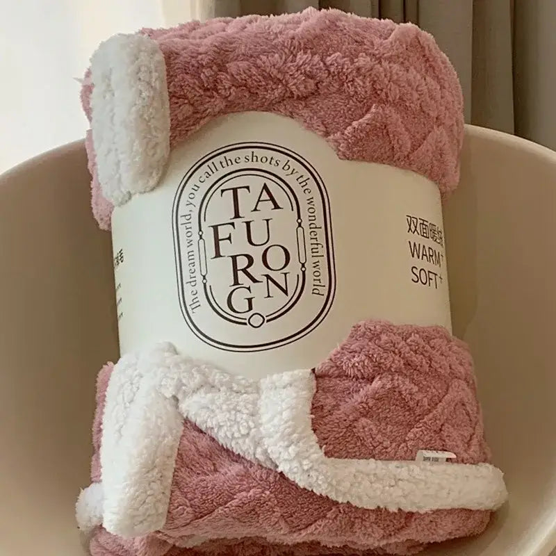 Cozy pink and white coral fleece blanket with a soft textured surface ideal for bedroom sherpa throws
