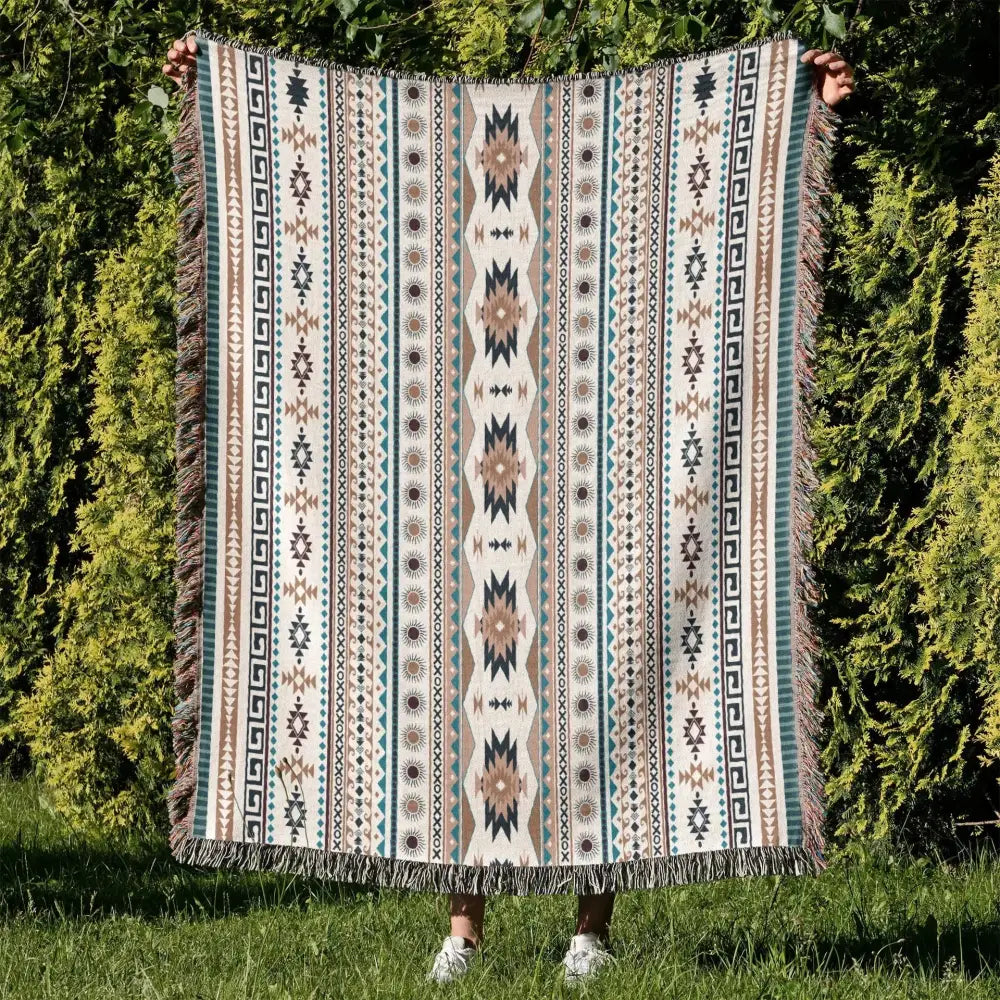 A cozy nordic camping woven throw blanket in cream teal and beige with fringe featuring a geometric pattern for living room decor