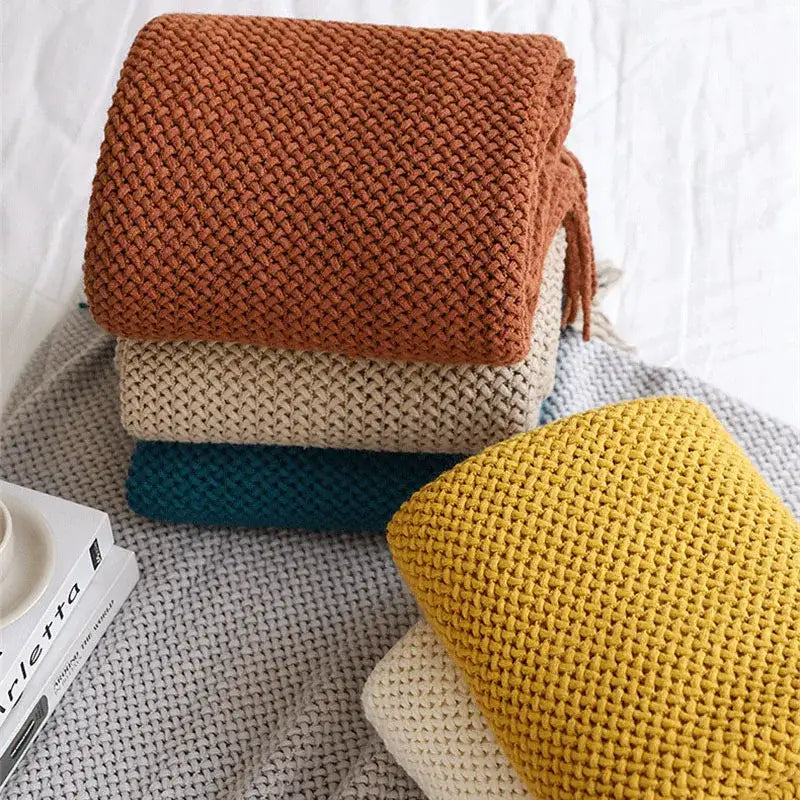 Stack of warm earthy tones cozy nordic knit textured tassel throw blankets ideal for nordic knit sofa decorbites cozy nordic