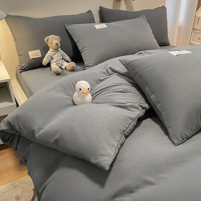 Gray cotton duvet cover set with matching pillows and plush white duck toy by decorbites cozy plaid bedroom bedding