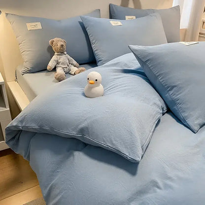 Soft light blue cotton bedding set with matching pillows and plush teddy bear featuring decorbites cozy plaid duvet cover