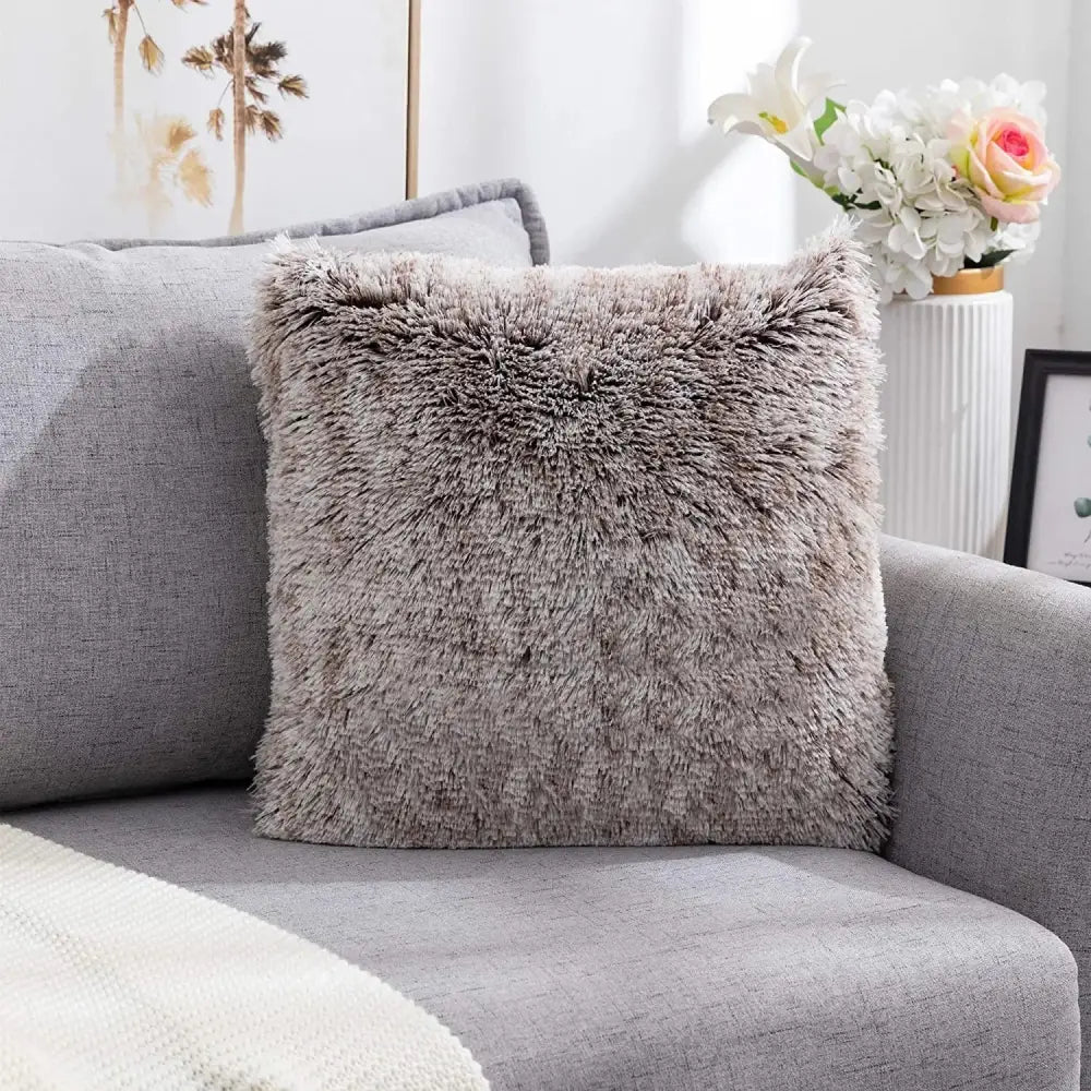 A gray cozy plush fur cushion cover with soft shaggy texture on a modern sofa for decorbites cozy plush decor