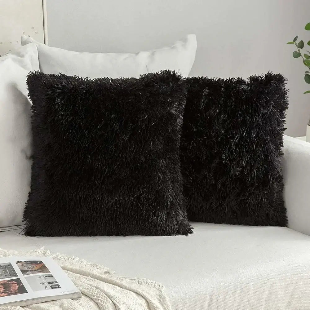 Two black fluffy faux fur throw pillows with shaggy texture for decorbites cozy plush cushion cover use