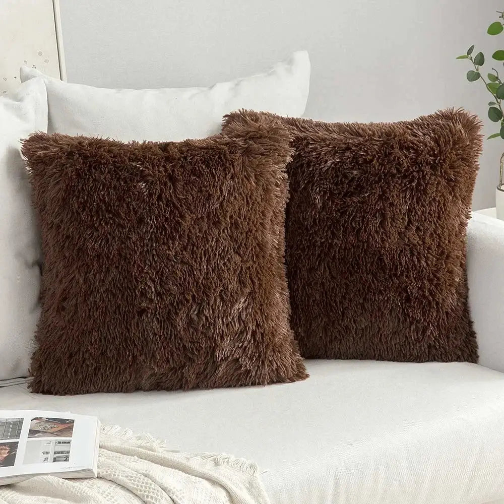 Two chocolate-brown cozy plush fur throw pillows with soft shaggy texture on white couch decorbites cushion cover