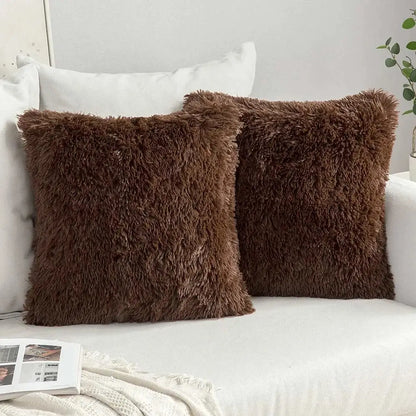 Two chocolate-brown cozy plush fur throw pillows with soft shaggy texture on white couch decorbites cushion cover