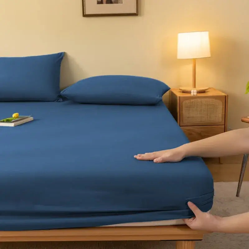Cozy solid blue fitted sheet with smooth stretchy fabric snugly covering the mattress by decorbites cozy solid color