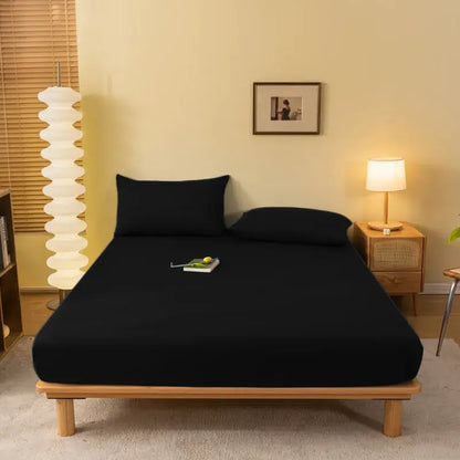 Black fitted sheet with smooth stretchy fabric snugly covering mattress and pillows decorbites cozy solid color