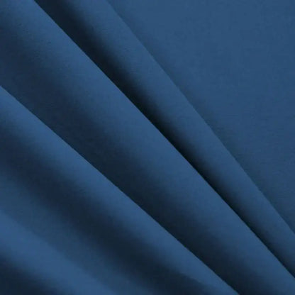 Cozy solid blue stretchy fitted sheet in deep navy blue fabric with soft texture and subtle folds for mattress cover decorbites