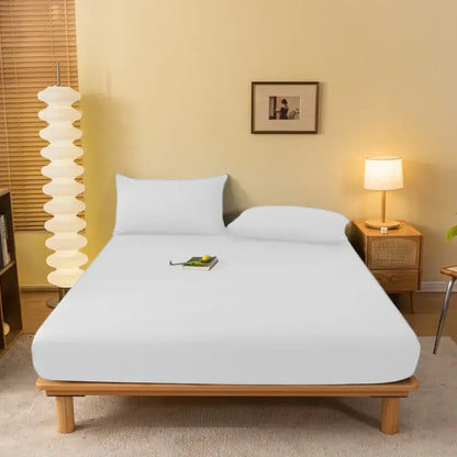 White fitted sheet with smooth stretchy fabric on wooden bed frame from decorbites cozy solid color collection
