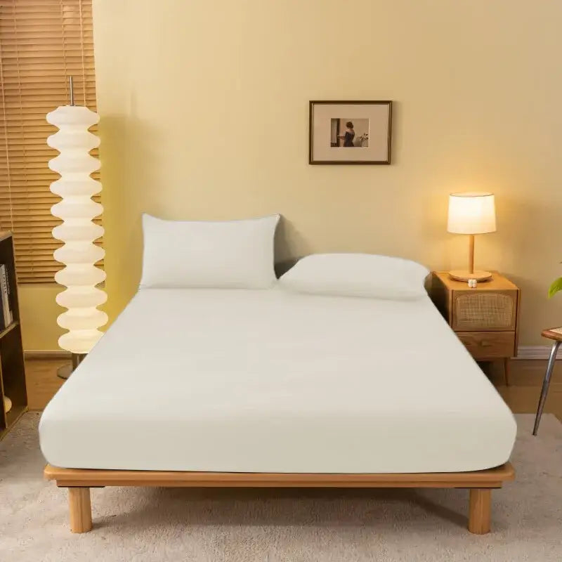White fitted sheet with smooth seamless finish on wooden bed frame by decorbites cozy solid color mattress cover