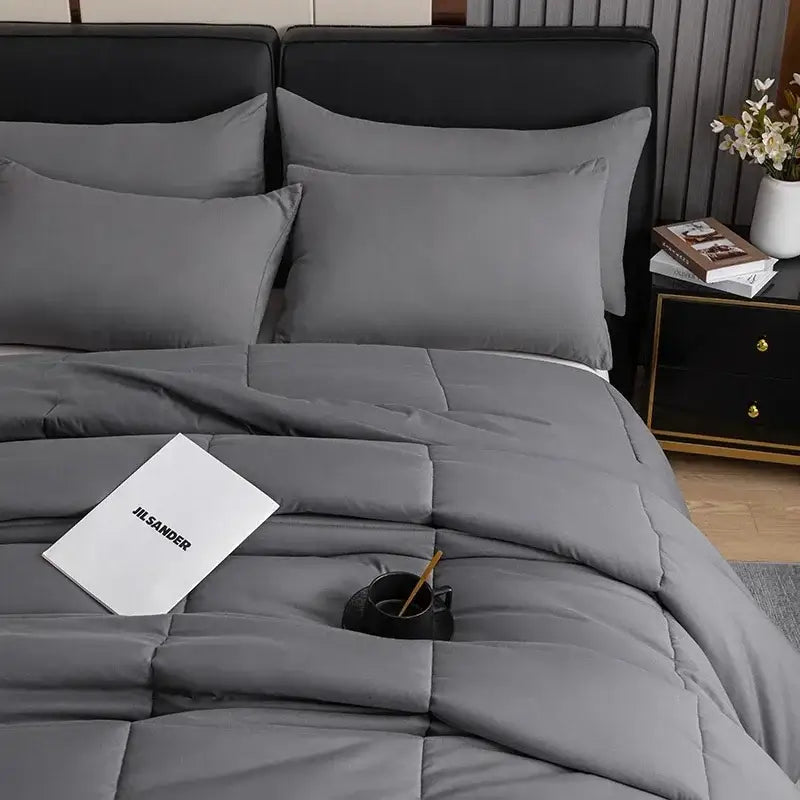 Gray quilted comforter with soft plush texture and subtle stitching from decorbites cozy spring queen duvet set