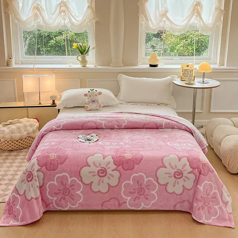Cozy white fleece blanket with soft plush texture featuring pink colorful flower patterns and white blossoms for bedroom decor