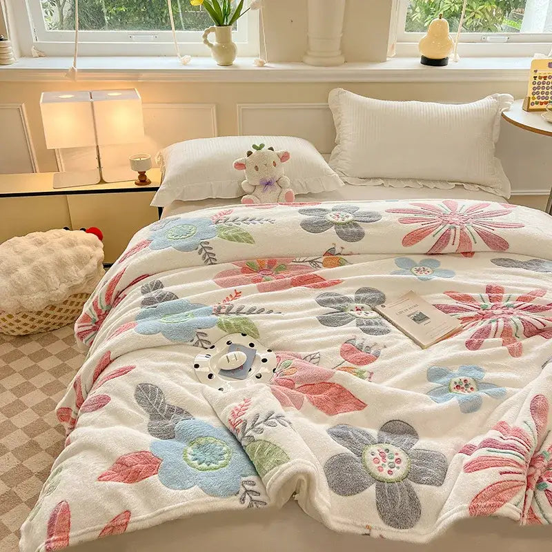 Cozy white fleece blanket with colorful flower patterns embroidered in pink blue and gray for bedroom decor