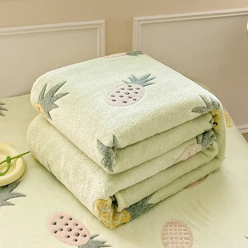 Pink plush blanket with playful cake rainbow and strawberry pattern contrasting cozy white fleece blanket with colorful flower patterns