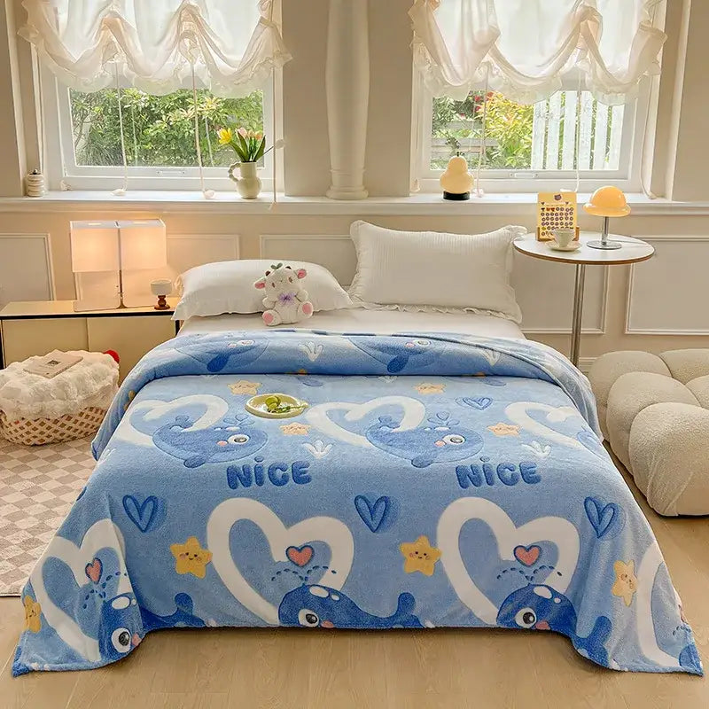 Light blue plush blanket with playful whales white hearts yellow stars and nice text complements colorful flower patterns decor