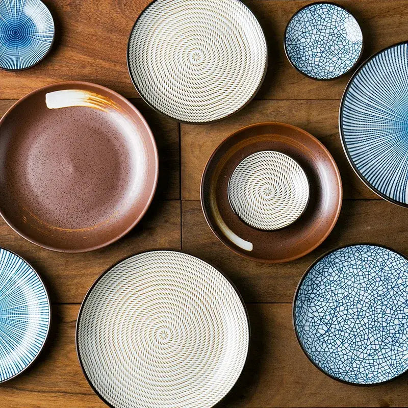 A decorbites ceramic dinner plate set featuring crackle glaze blue, earthy brown, and white spiral patterned plates