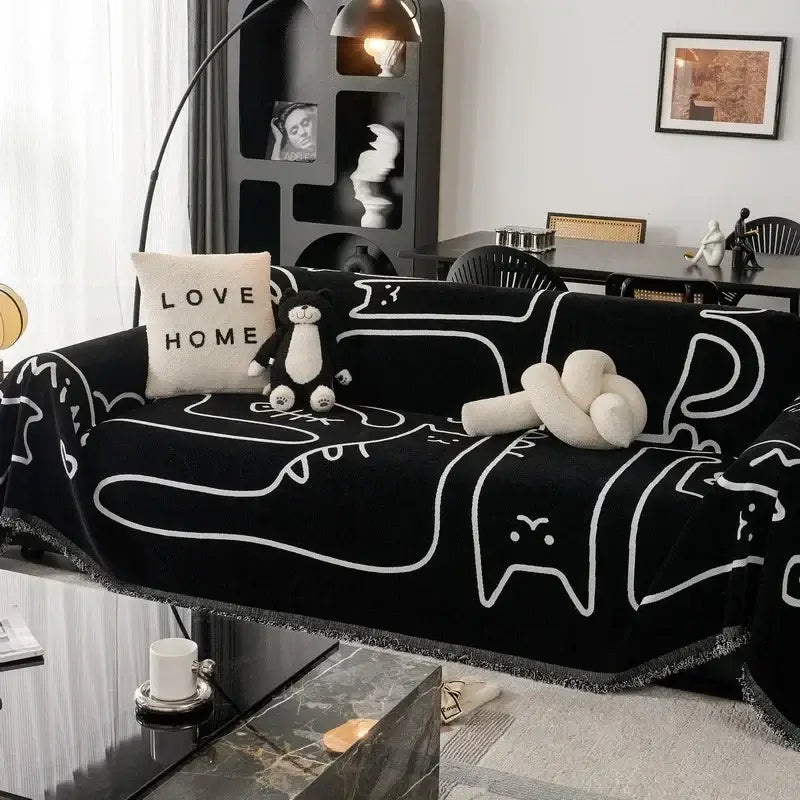 Black chenille sofa cover with white outlined cartoon cat patterns and fringed edge for living room use