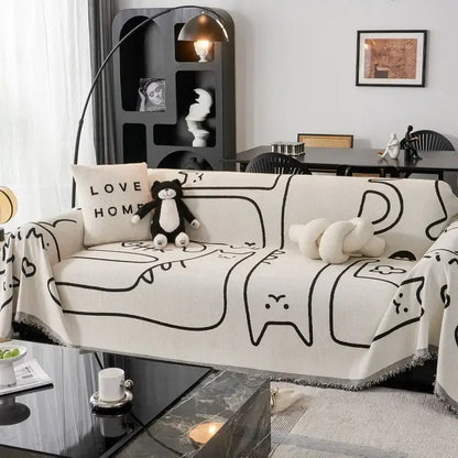Cream and black cat print chenille sofa cover with frayed edges featuring line-drawn cartoon cat patterns
