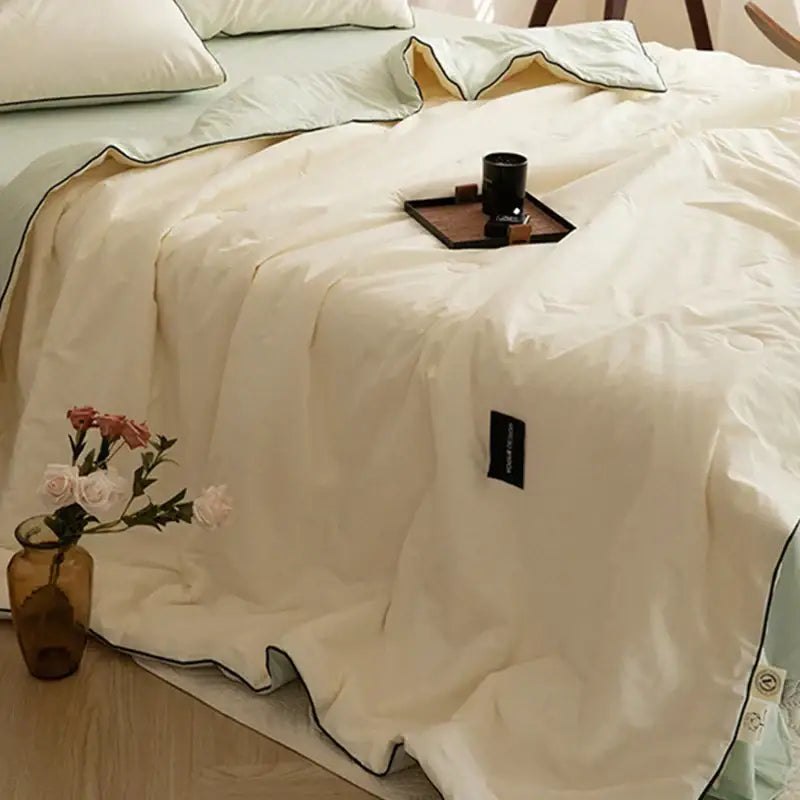 Cream-colored quilted comforter with black piping and label for decorbites ice cream cool feel summer quilt set
