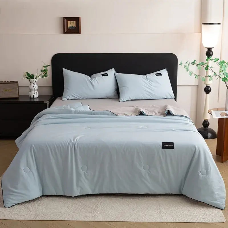 Light blue quilted comforter with stitched circles and black label for cream cool feel ice cream cool bedroom decorbites set