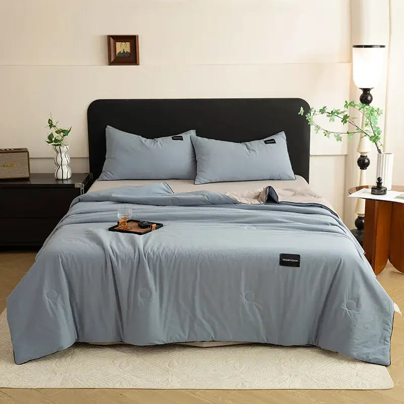 Light blue quilted comforter with subtle circular stitching and black label from decorbites ice cream cool summer set