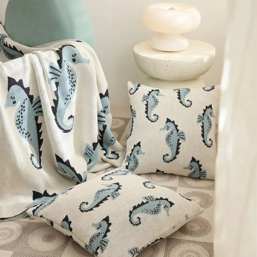Cream and blue cute sea horse cotton knit throw blanket and pillows with light blue seahorse pattern for decorbites cute sea decor
