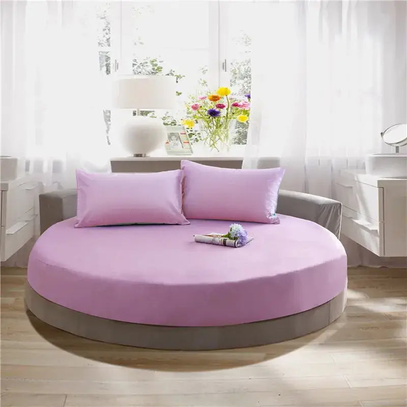 Pink round fitted bed with matching pillowcases and cream and gray fitted bed sheet set for bedroom decor