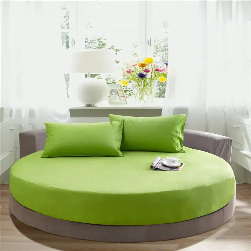 Vibrant lime green circular bed with plush cushioning and matching pillows featuring a sleek gray fitted bed sheet set