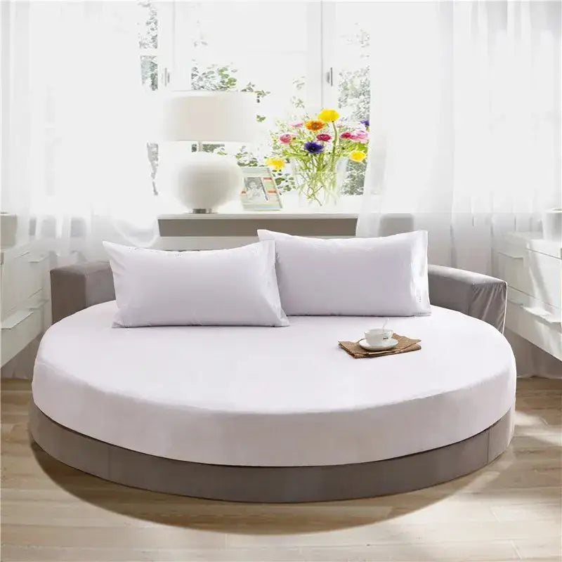 Cream and gray round fitted bed with white mattress and bed sheet set featuring two matching pillows for bedroom decor
