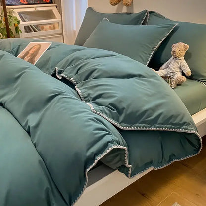 Teal-colored quilted comforter with white zigzag stitching features cozy shell edges in a decorbites cozy shell bedding set